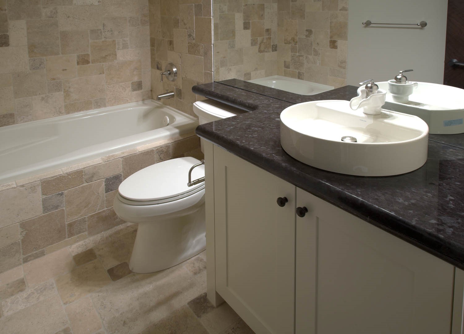 white bathroom sink installed in granite counter